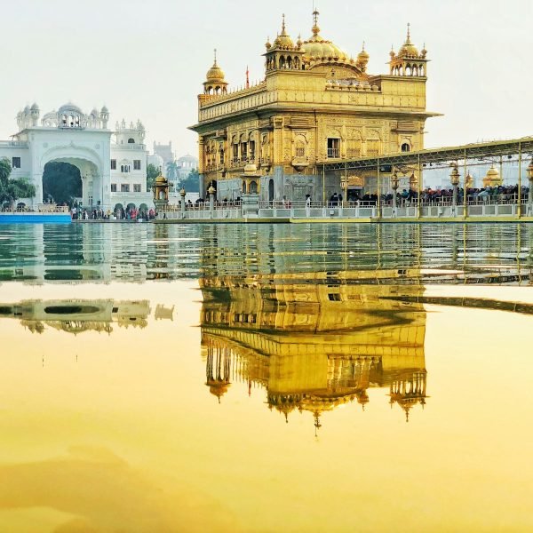 yellow temple near body of water