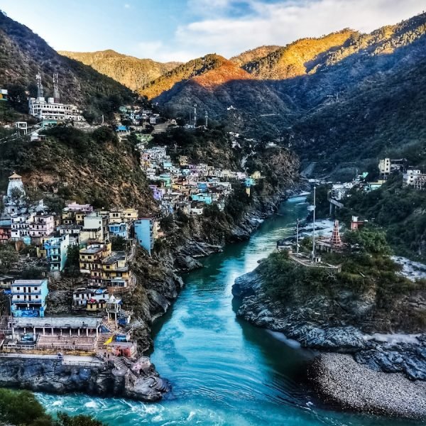 a river running through a lush green hillside